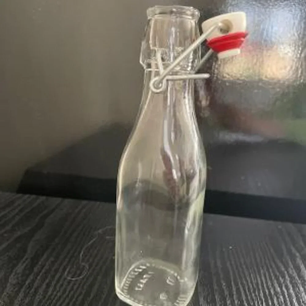 Eight Ounce Clear Bottle With Swing Lid. Italy